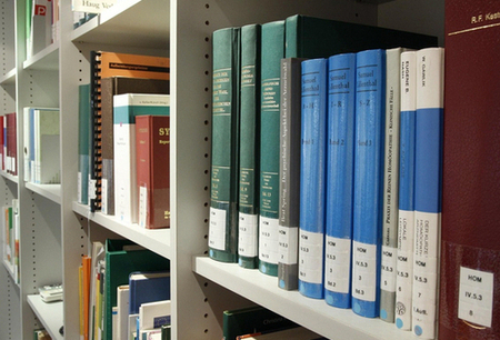 Books lined up on library shelving.